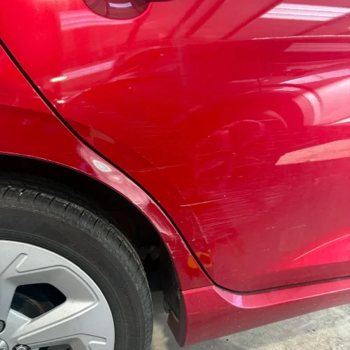 scratch repair before on red suzuki swift